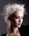 Platinum blonde hair styled into an updo with curls