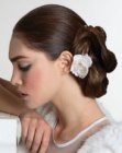 Wedding hairstyle with a chignon and a flower