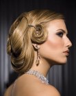 Up-style with an arrangement of draped lengths and pin curls