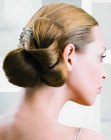 Updo with smooth hair and a large loose knot