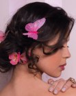 Updo decorated with butterfly hairpins