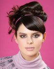 Retro sixties updo with a headband and S-shape bangs