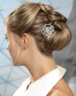 Up-style with a bun and jewelry hairpins