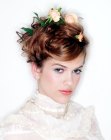 Up style with pinned flowers for mid-length to long hair