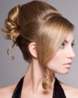 Up-style with overlapping bands of hair and a spiral curl
