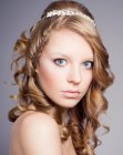 Updo hairstyle with a braid along one side and a tiara