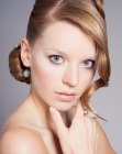 Classic updo with a high crown, a chignon and a swirled hair strand