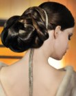 Exotic updo with sleek hair and a chignon