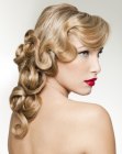 Elegant hairstyle with a fall of curls