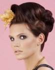 Updo with a silk flower for a festive occasion