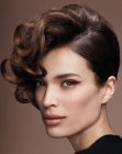 Asymmetrical updo with a sleek and a curly side