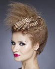 Updo with crimped hair and feathery accents