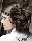Hairdo with feathers and braiding