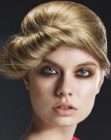 Updo with a rolled front and round shapes