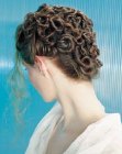 Updo with tight twisted tendrils