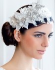 Hair with a low bun and a vintage headpiece with flowers