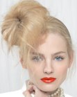 Updo with a frontal chignon and loose strands