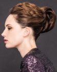 Updo with a large chignon for wavy hair