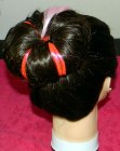 Hairdo with a sock bun and colored extensions