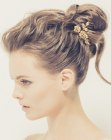 Romantic updo with a bun and flowers