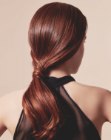 Glamorous low ponytail with waves along the tips of the hair