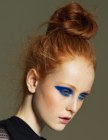 Red hair styled into a messy bun