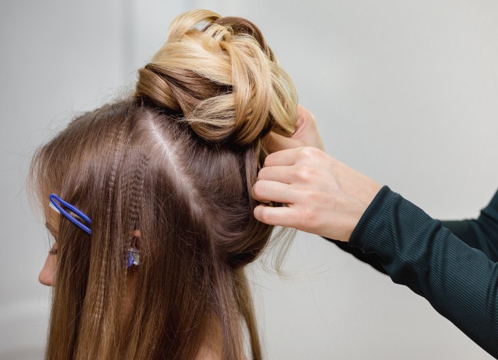 Hair stylist creating an updo