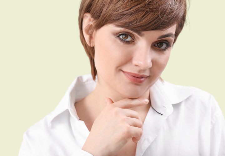 Woman with short hair wearing a buttoned shirt