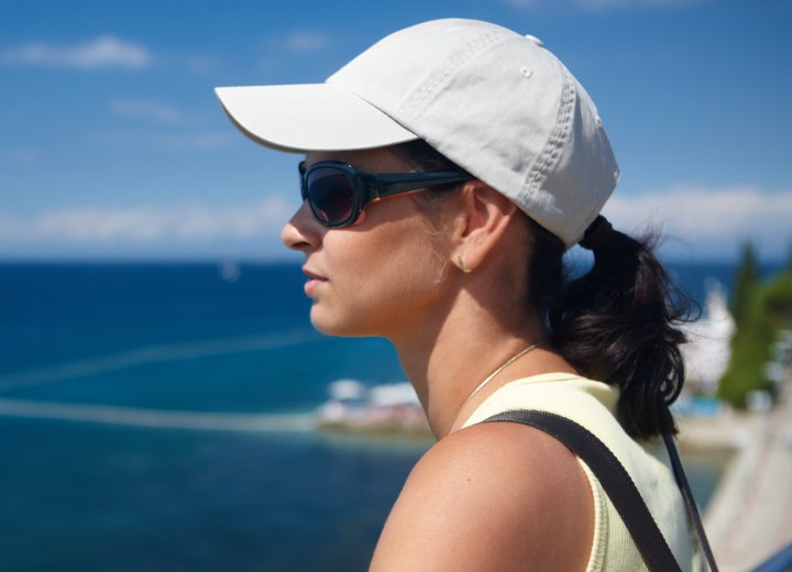 Ponytail and baseball cap