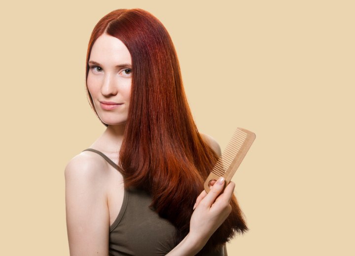 Young woman who is combing her hair