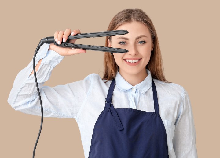 Female cosmetologist with a flat iron