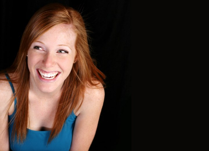 Girl with reddish hair wearing a blue tank top