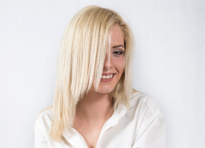 Hair model with long razor-cut blonde hair