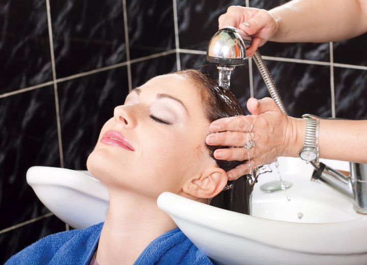Shampooing a salon client's hair