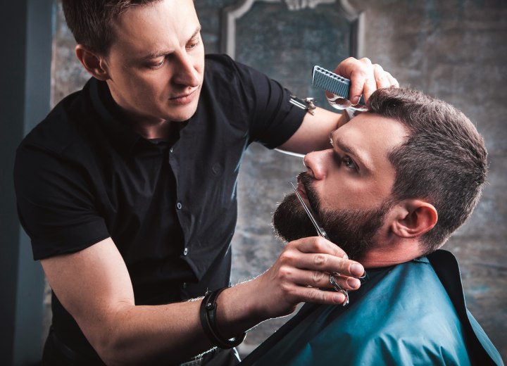 Barber trimming a client's mustache