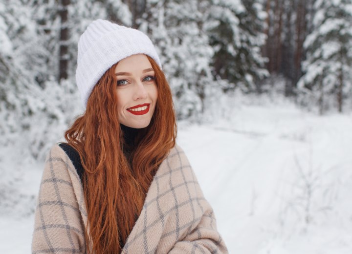 Woman with long red hair in the snow