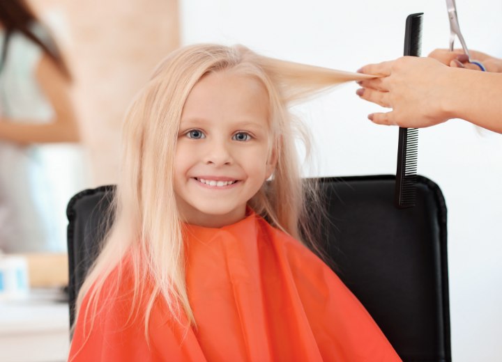 Happy little girl in a hair salon