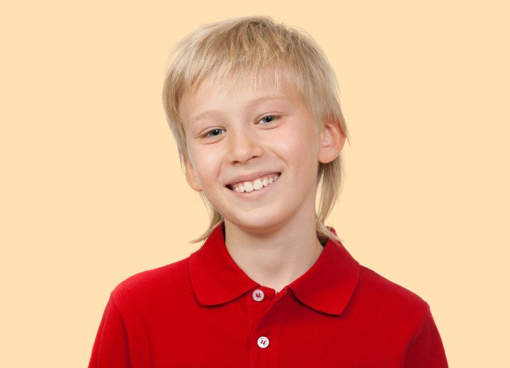 Young boy with a mullet haircut