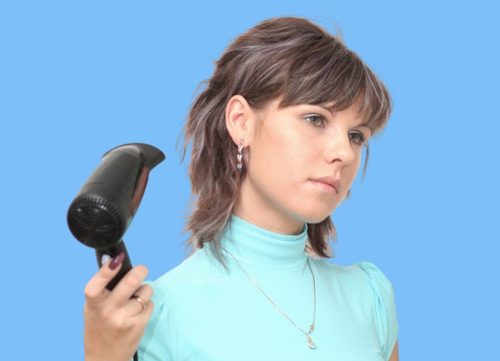 Young lady with blow dryer