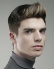 Men's hairstyle with clipper cut sides and back