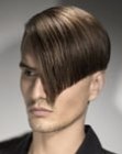 Men's haircut with a sleek top and clippered nape