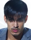 Sleek men's hair with a fringe