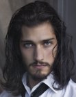 Long hair with natural waves and a beard