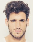 High volume hairdo for men with natural curls