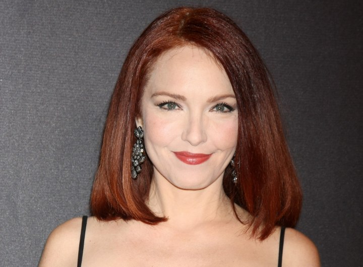 Amy Yasbeck wearing her red hair in a long bob