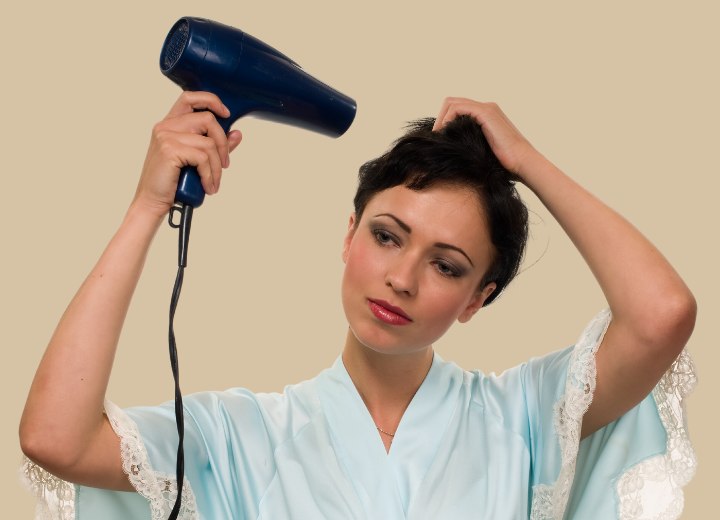 Woman who is blow drying her short hair