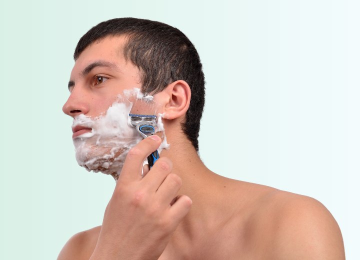 Man who is shaving his beard