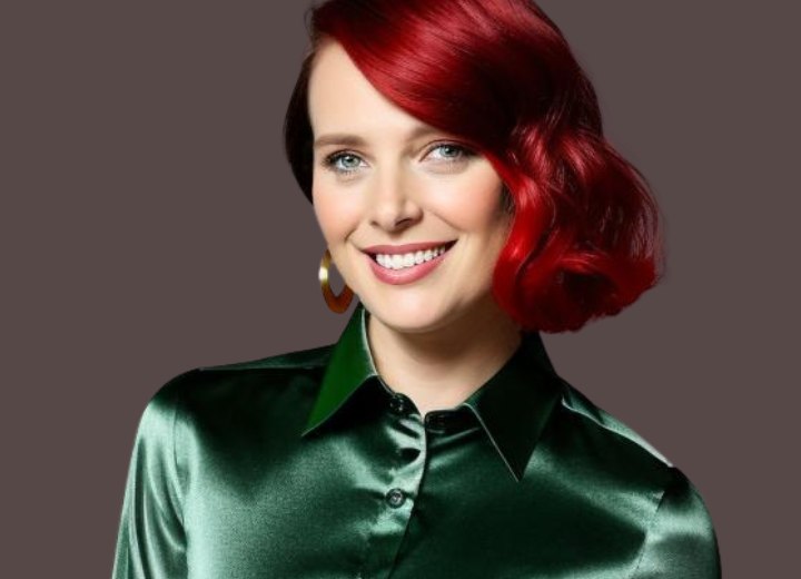 Woman with red hair wearing a green satin blouse