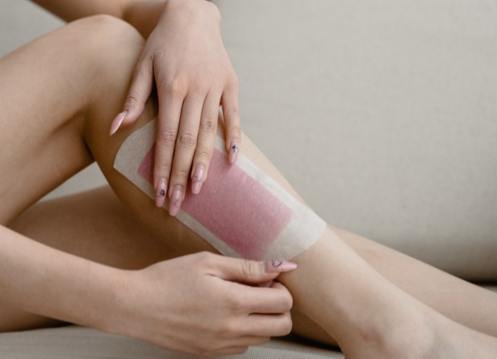 Waxing hair with a cold wax strip