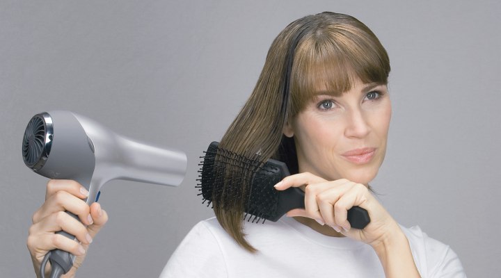 Blow dry hair over a large round brush